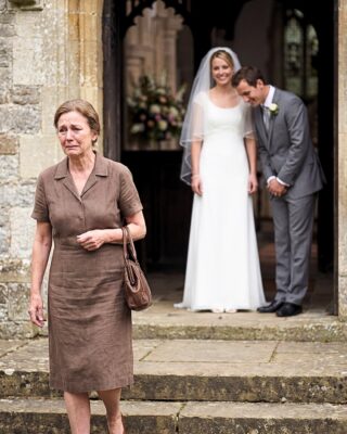When I arrived at my son’s wedding, he blocked my path at the church door and said: “I didn’t invite you, Mom. The whole family decided you’re no longer a part of us.” I looked at him, gripped my purse, and replied in a low voice: “That’s fine, son… but don’t forget to check your phone.” What no one knew was that, that afternoon, the truth was already on its way.